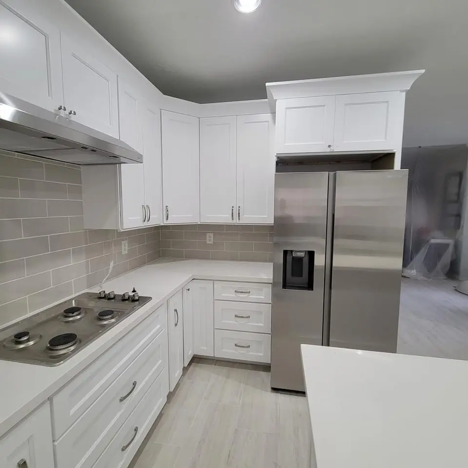 Kitchen renovation showing installation of modern cabinets